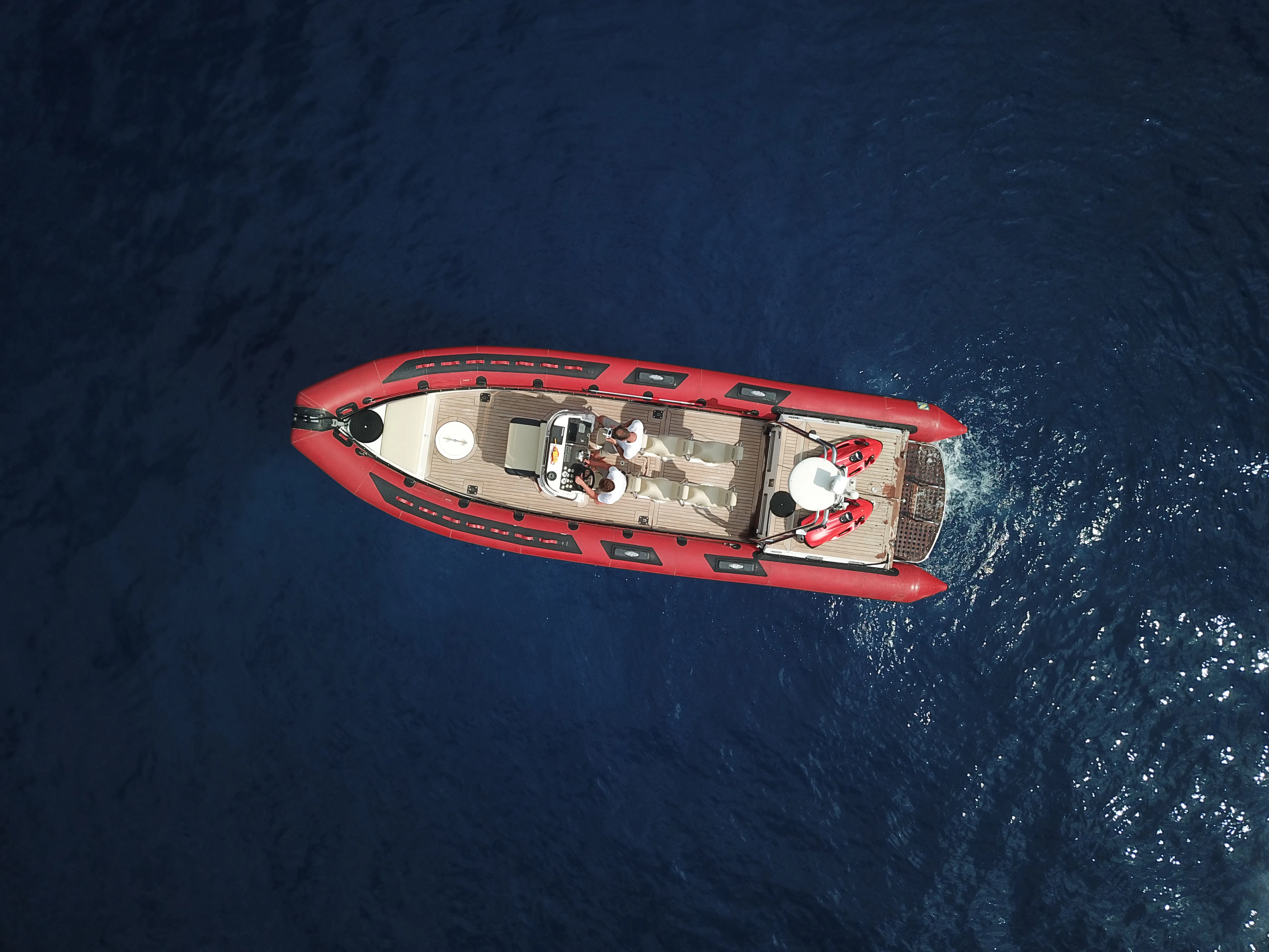 a red and white boat in the water aboard STEEL Yacht for Sale