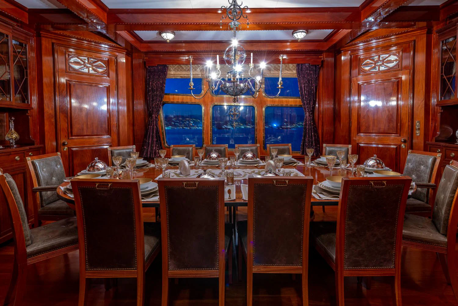 a large room with a table and chairs aboard STEEL Yacht for Sale