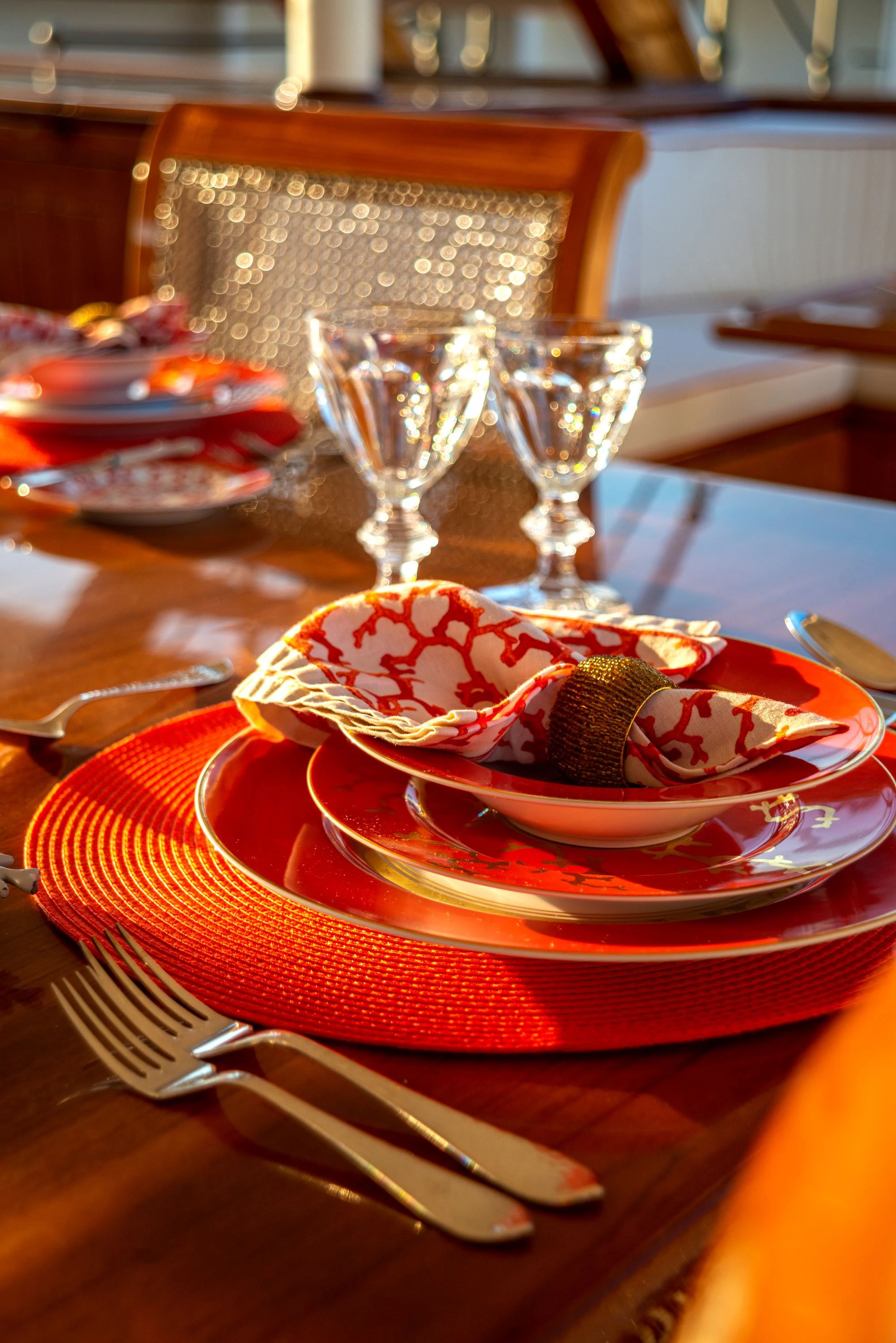 a plate of food and a glass of wine on a table aboard STEEL Yacht for Sale