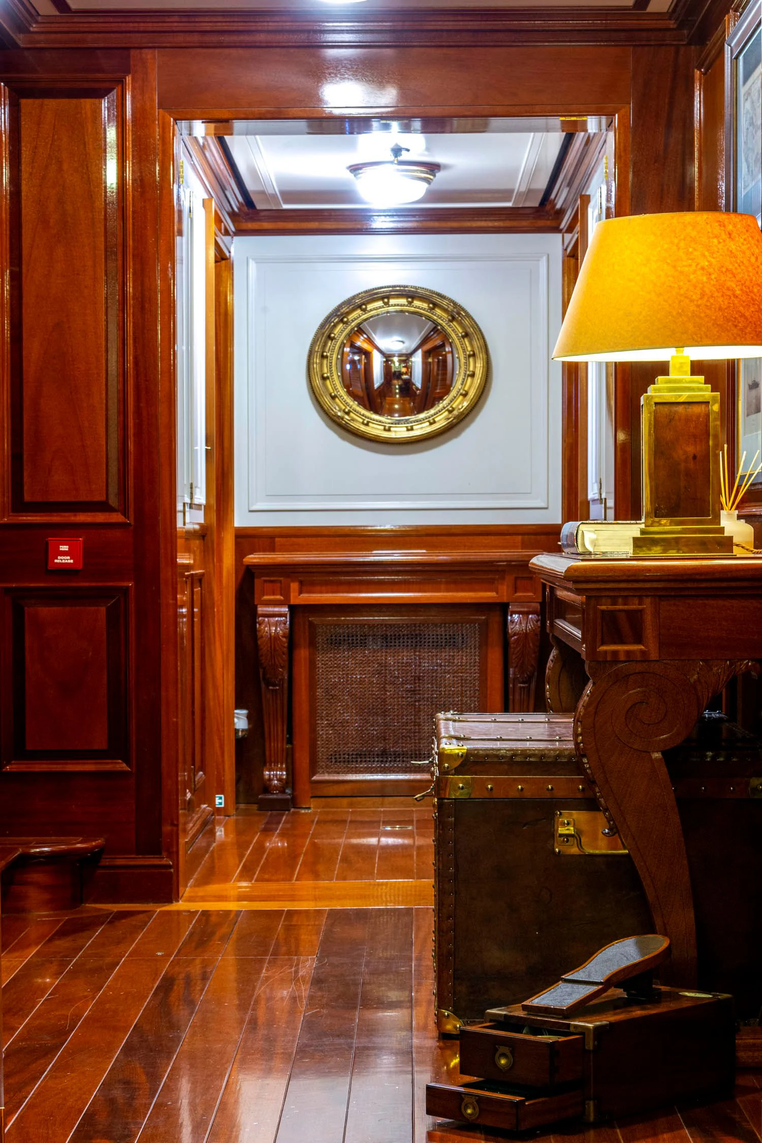 a room with a clock and a piano aboard STEEL Yacht for Sale