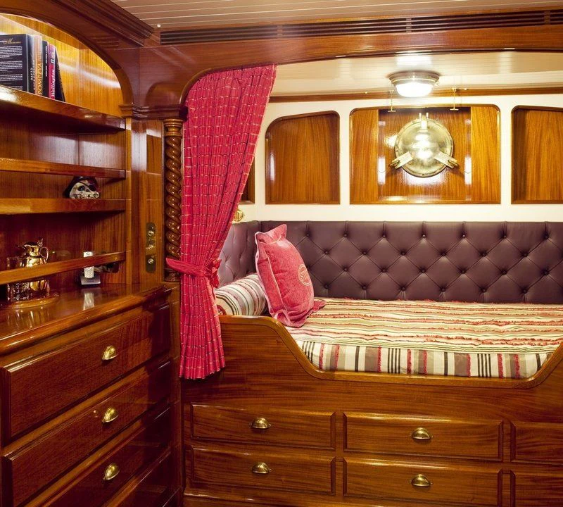 a room with a bed and a mirror aboard STEEL Yacht for Sale