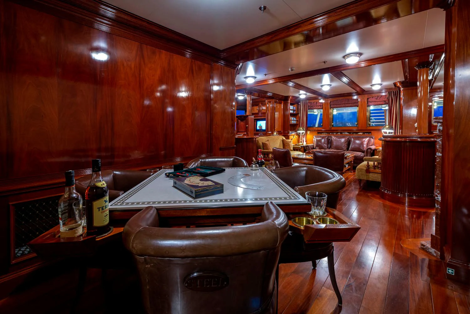 a room with a table and chairs aboard STEEL Yacht for Sale