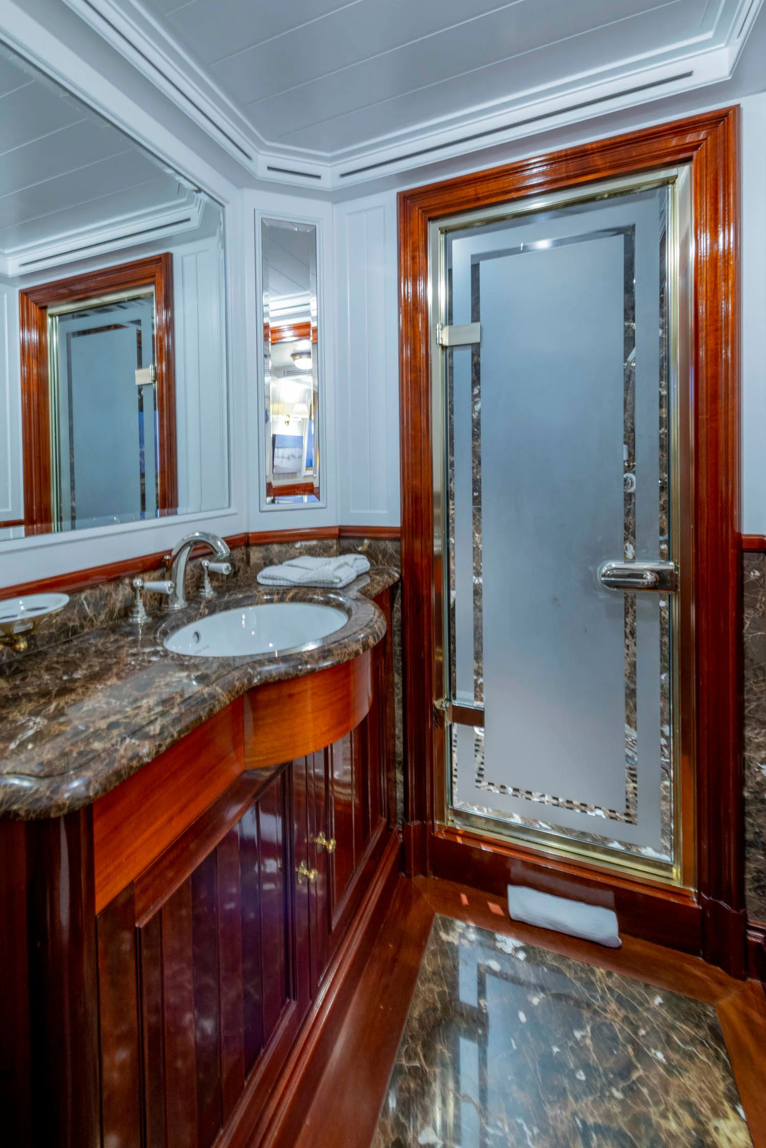 a bathroom with a sink and a mirror aboard STEEL Yacht for Sale