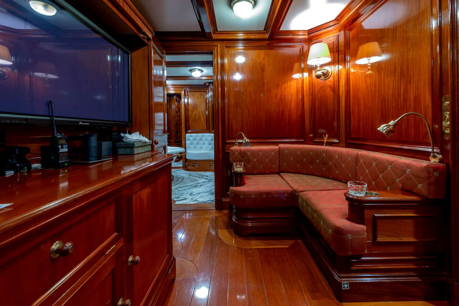 a living room with a wood paneled wall aboard STEEL Yacht for Sale