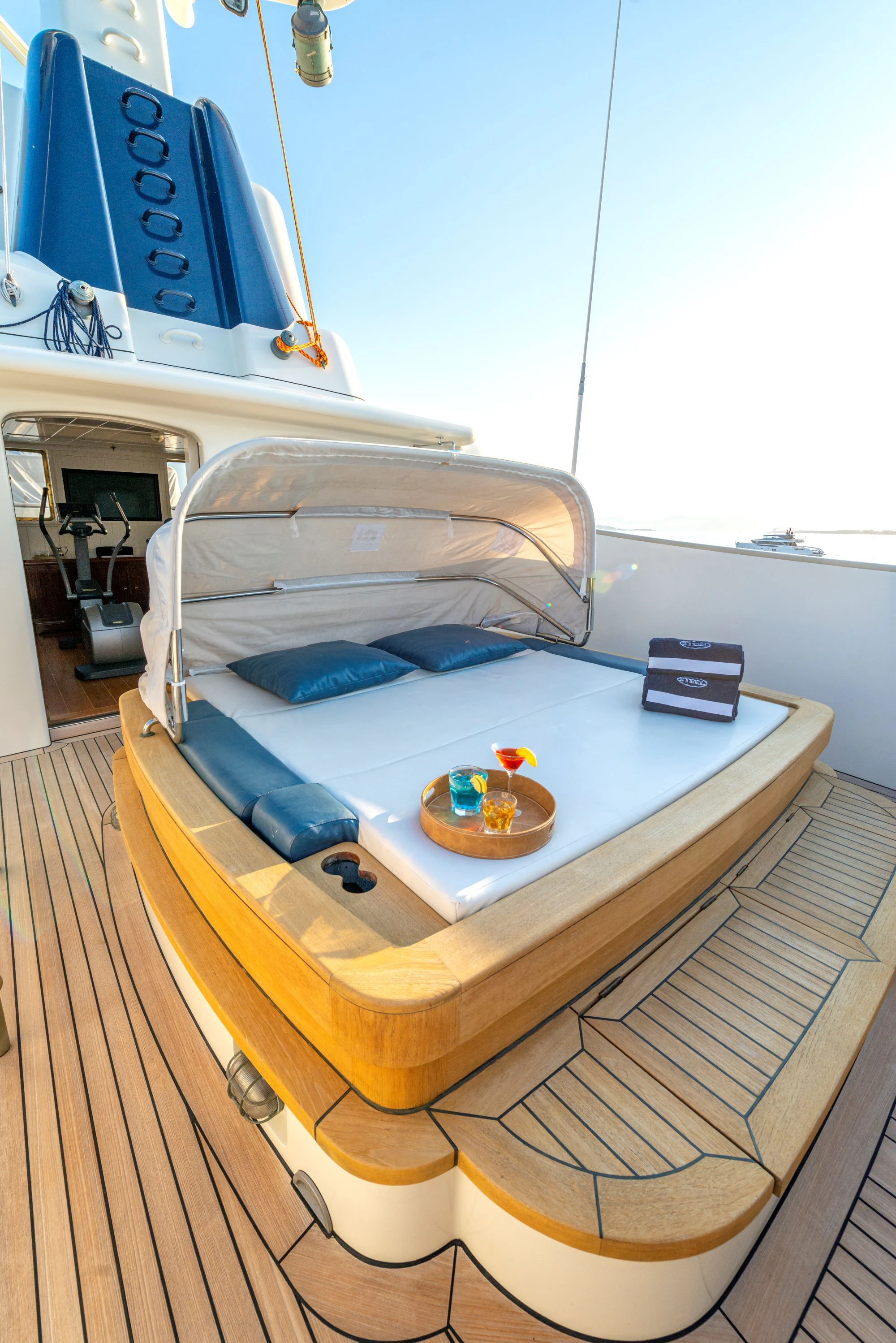 a bed with a blue blanket aboard STEEL Yacht for Sale