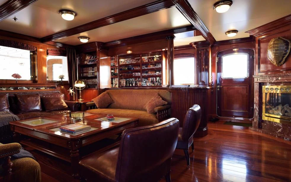 a living room with leather couches aboard STEEL Yacht for Sale