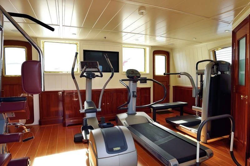 a room with a treadmill and a treadmill aboard STEEL Yacht for Sale