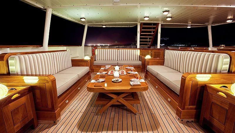 a room with couches and a coffee table aboard STEEL Yacht for Sale