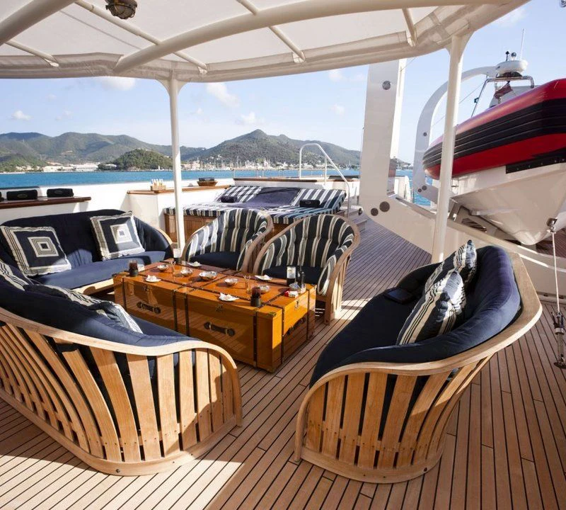 a boat with a table and chairs on it aboard STEEL Yacht for Sale