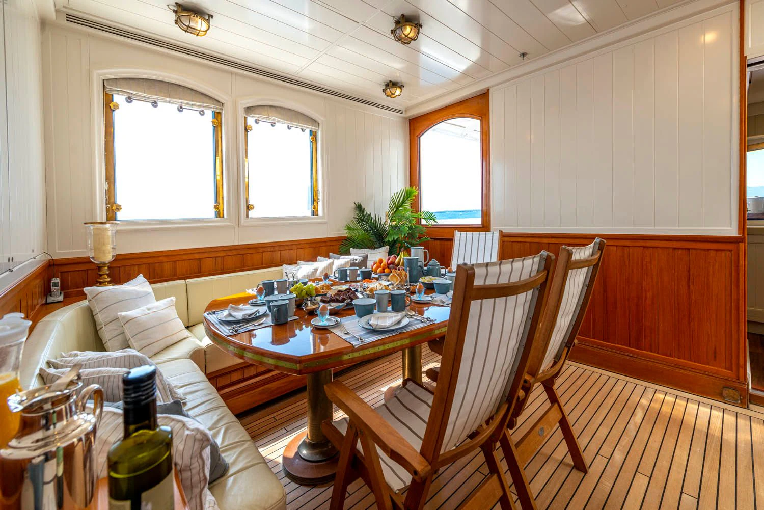 a dining room with a table and chairs aboard STEEL Yacht for Sale