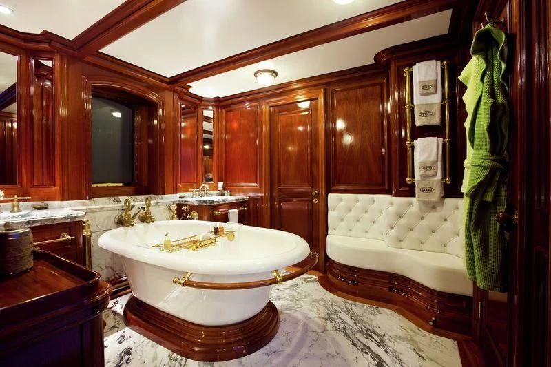 a bathroom with a tub sink and cabinets aboard STEEL Yacht for Sale