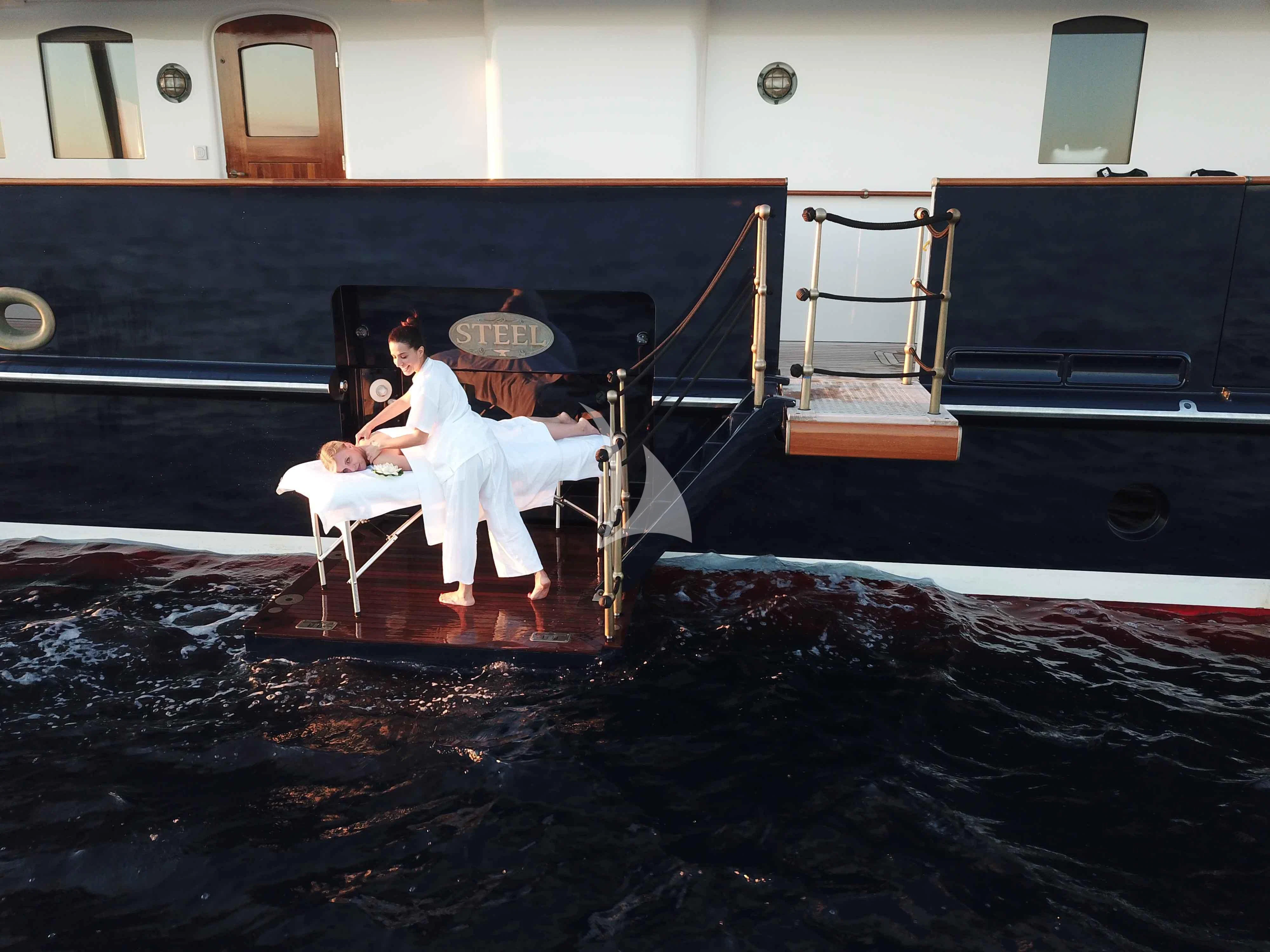 a couple of people sitting on a bench aboard STEEL Yacht for Sale
