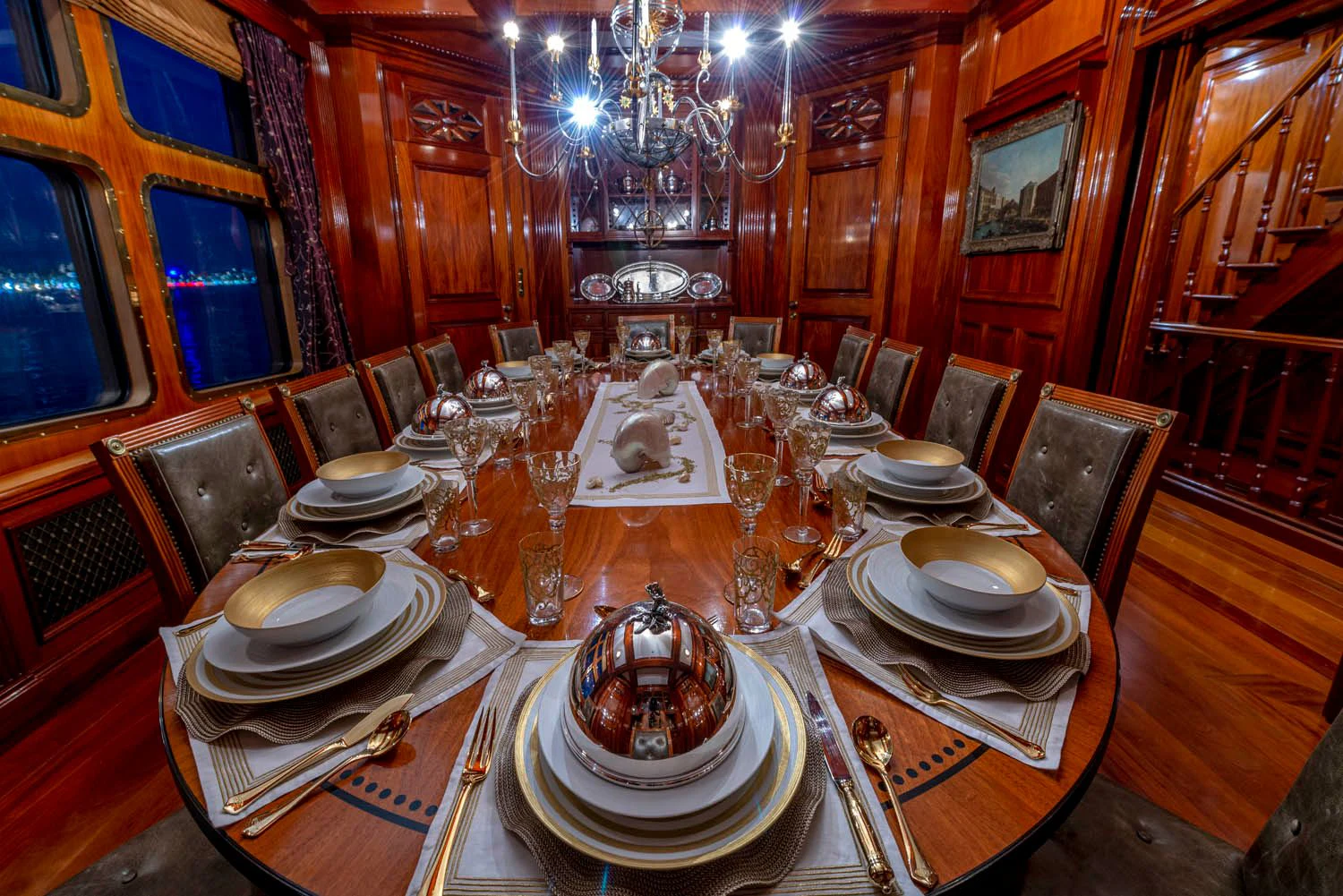 a table with plates and glasses on it aboard STEEL Yacht for Sale