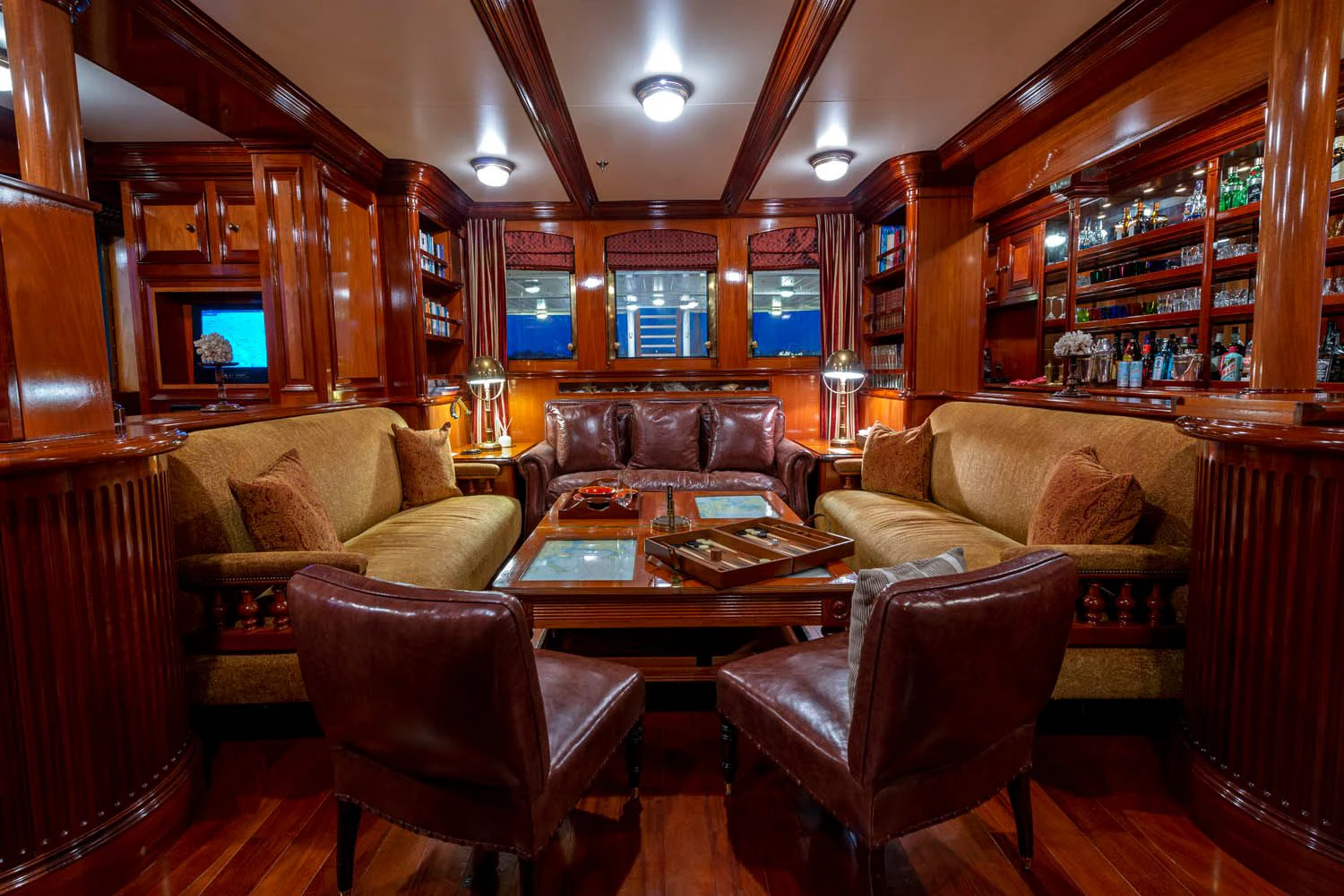 a living room with wood paneling aboard STEEL Yacht for Sale