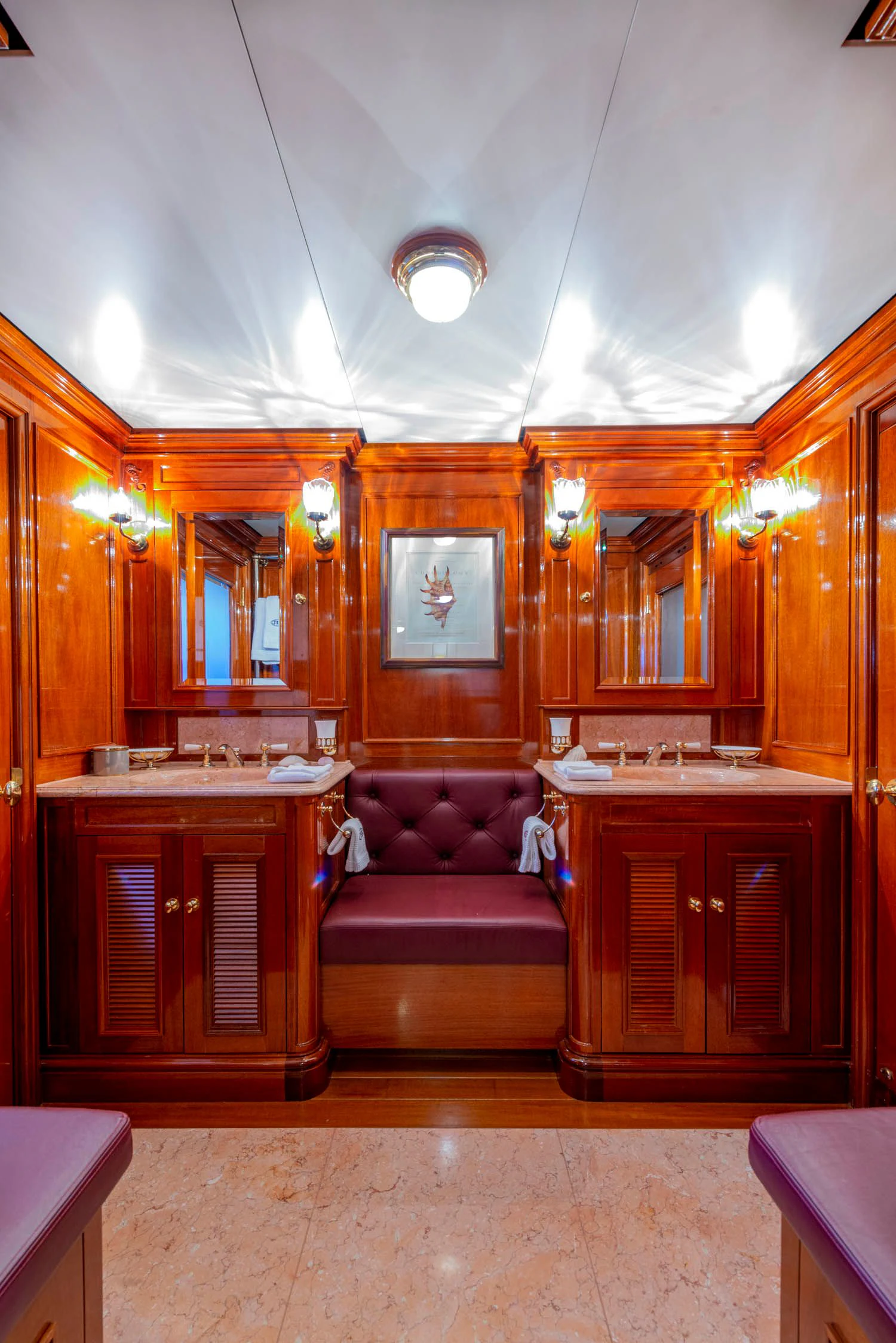 a living room with a couch and a mirror aboard STEEL Yacht for Sale