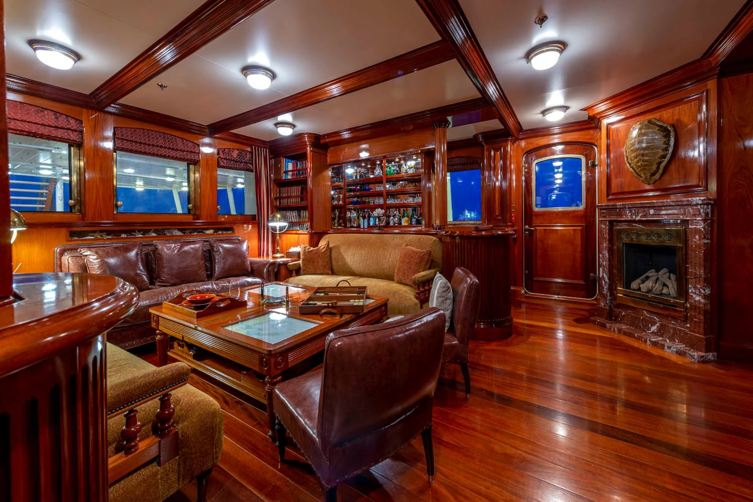 a living room with a fireplace aboard STEEL Yacht for Sale
