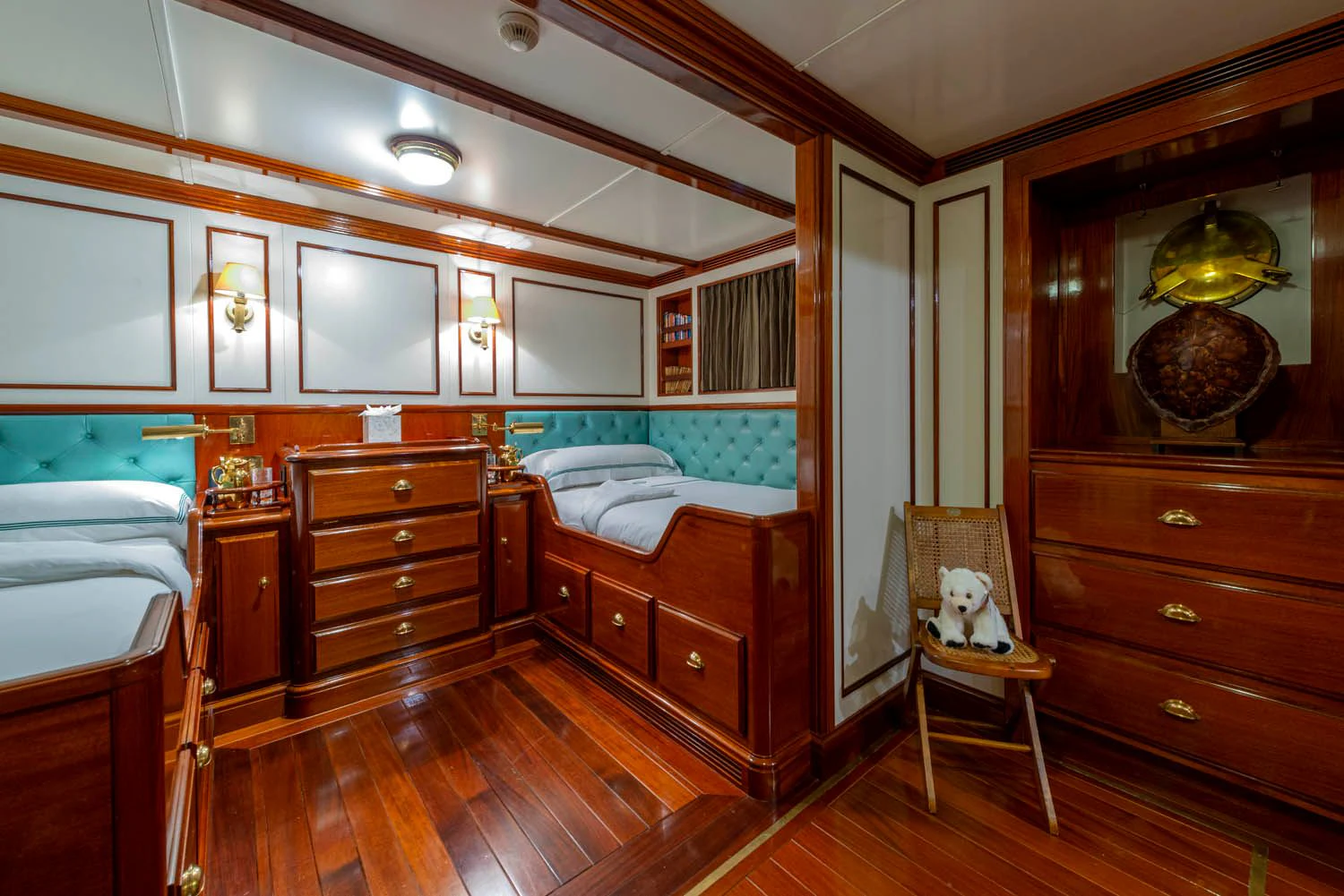 a bedroom with a wood floor aboard STEEL Yacht for Sale
