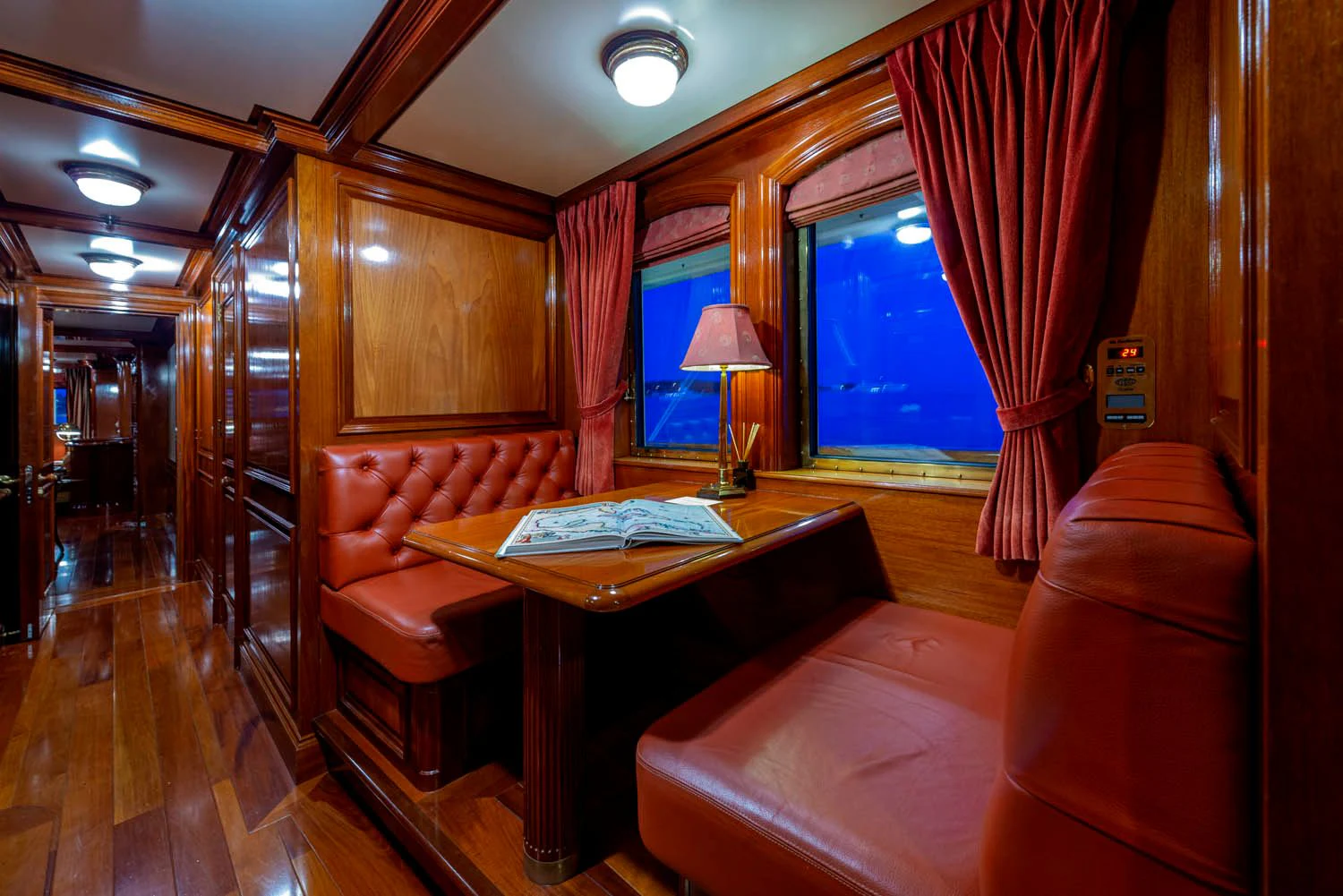 a room with a table and couch aboard STEEL Yacht for Sale
