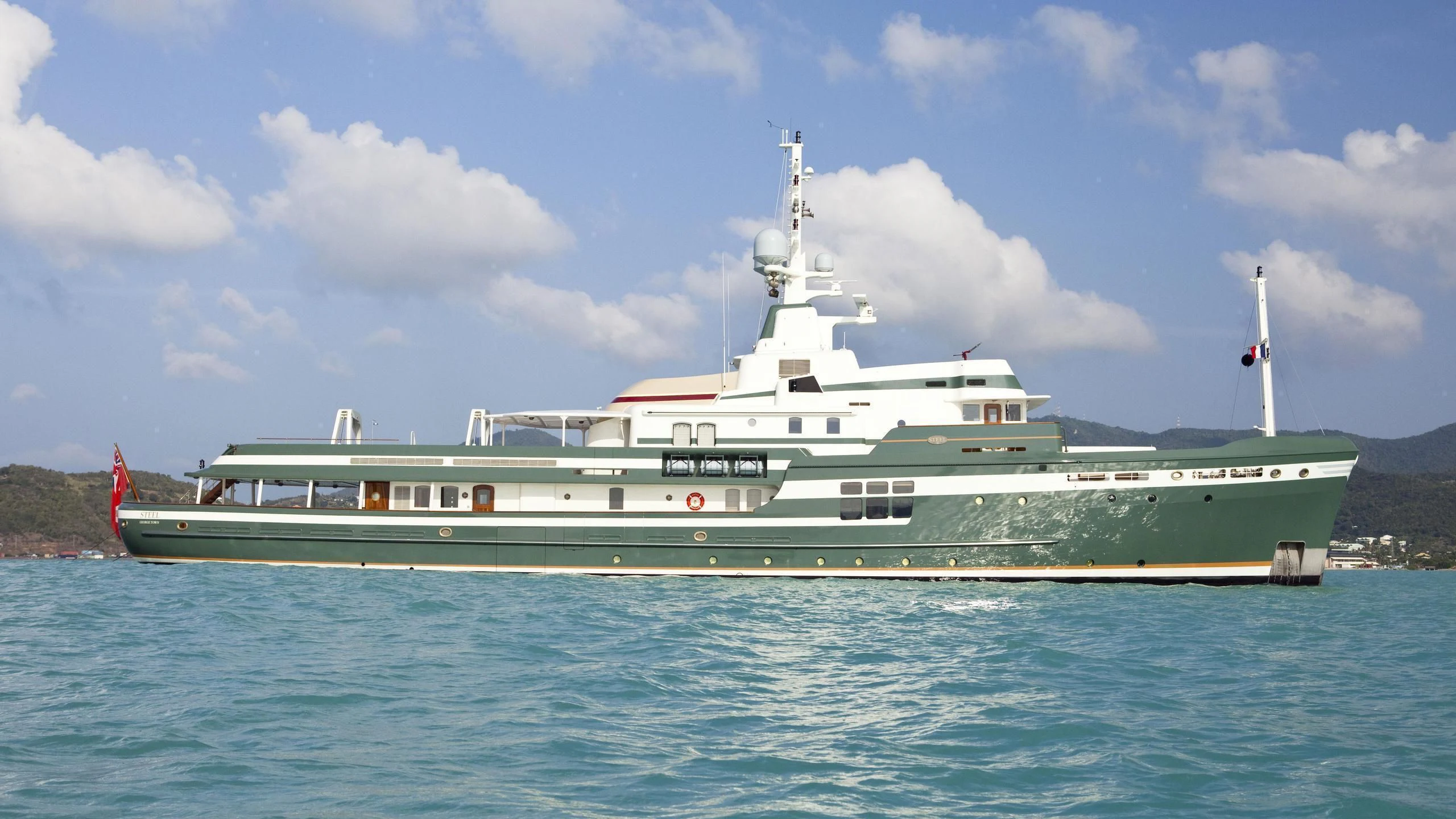 a large white boat on the water aboard STEEL Yacht for Sale