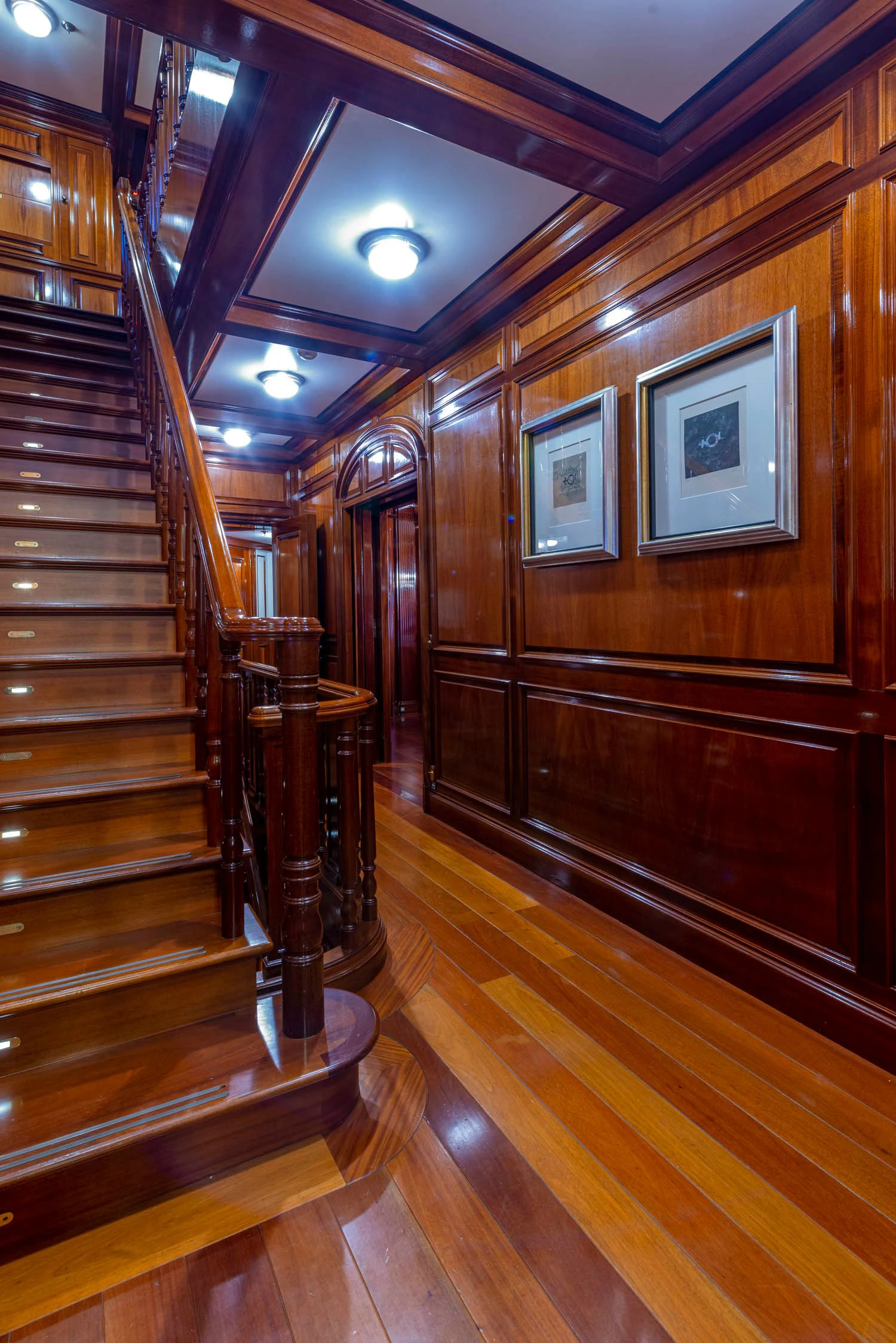 a wood staircase in a room aboard STEEL Yacht for Sale