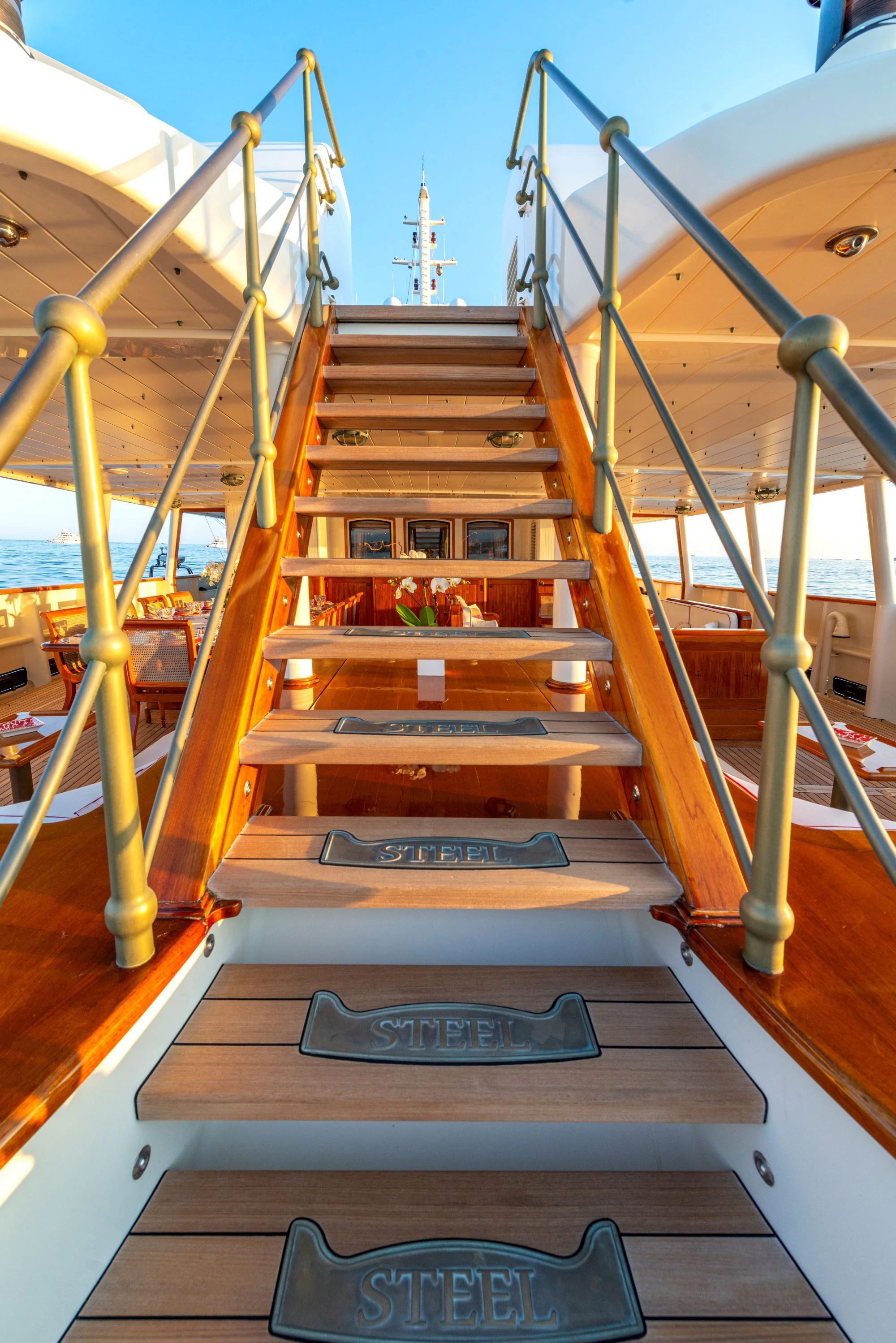 a wooden staircase with a railing aboard STEEL Yacht for Sale