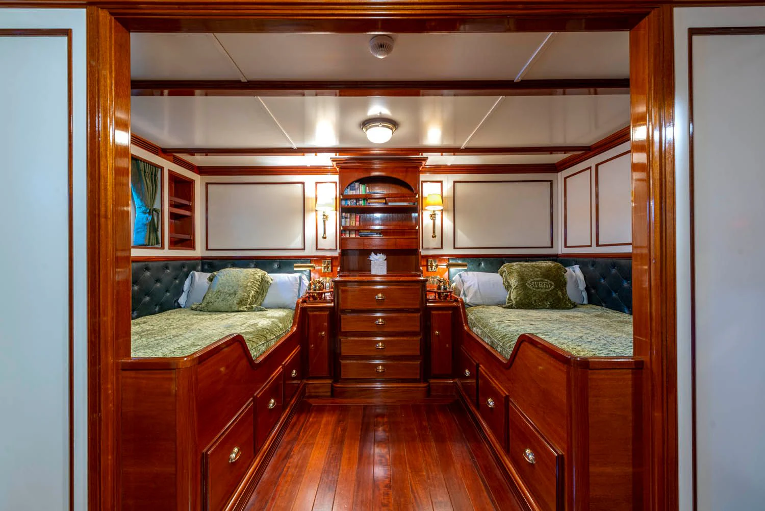 a room with a bed and a dresser aboard STEEL Yacht for Sale