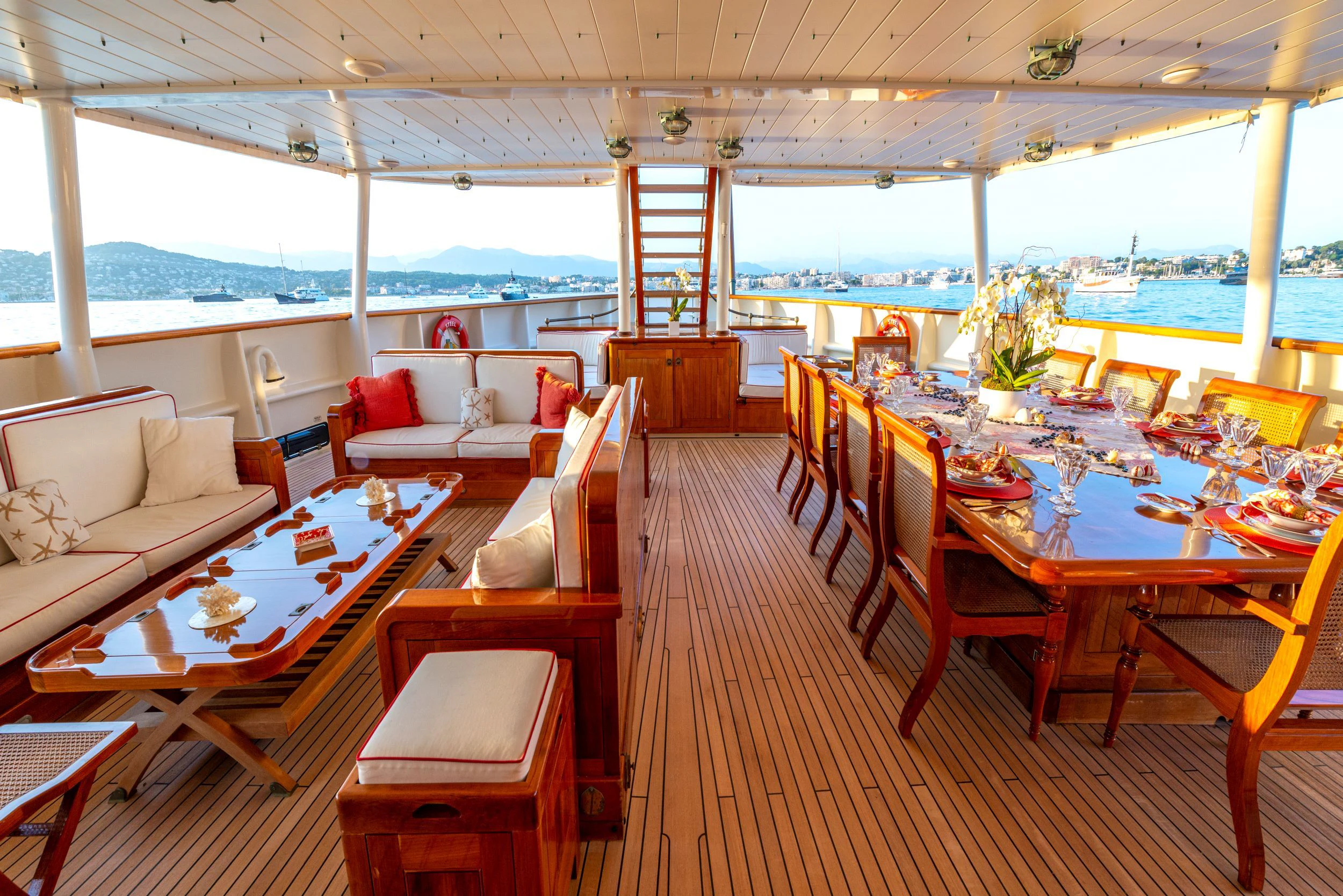 a room with tables and chairs aboard STEEL Yacht for Sale