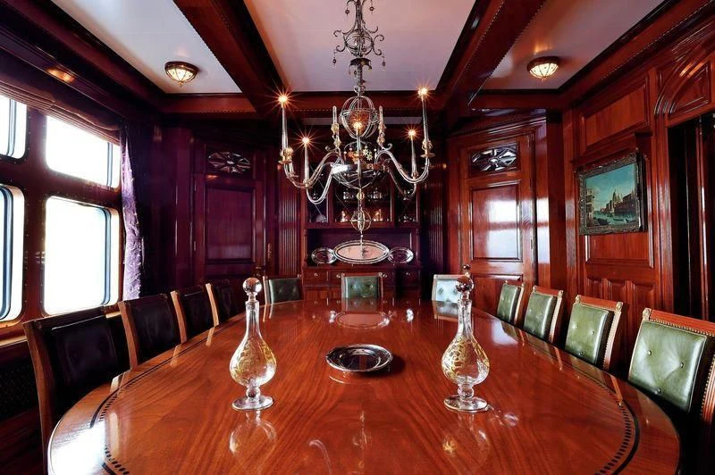 a large room with a chandelier and chairs aboard STEEL Yacht for Sale
