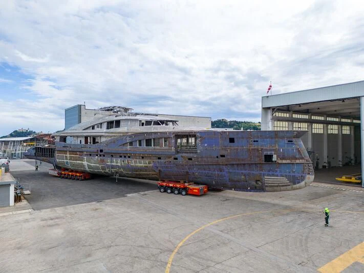 a large building with a truck parked in front of it aboard MADDAM C Yacht for Sale