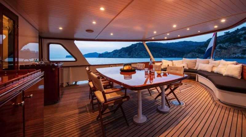 a table and chairs in a room aboard SANTA MARIA Yacht for Sale