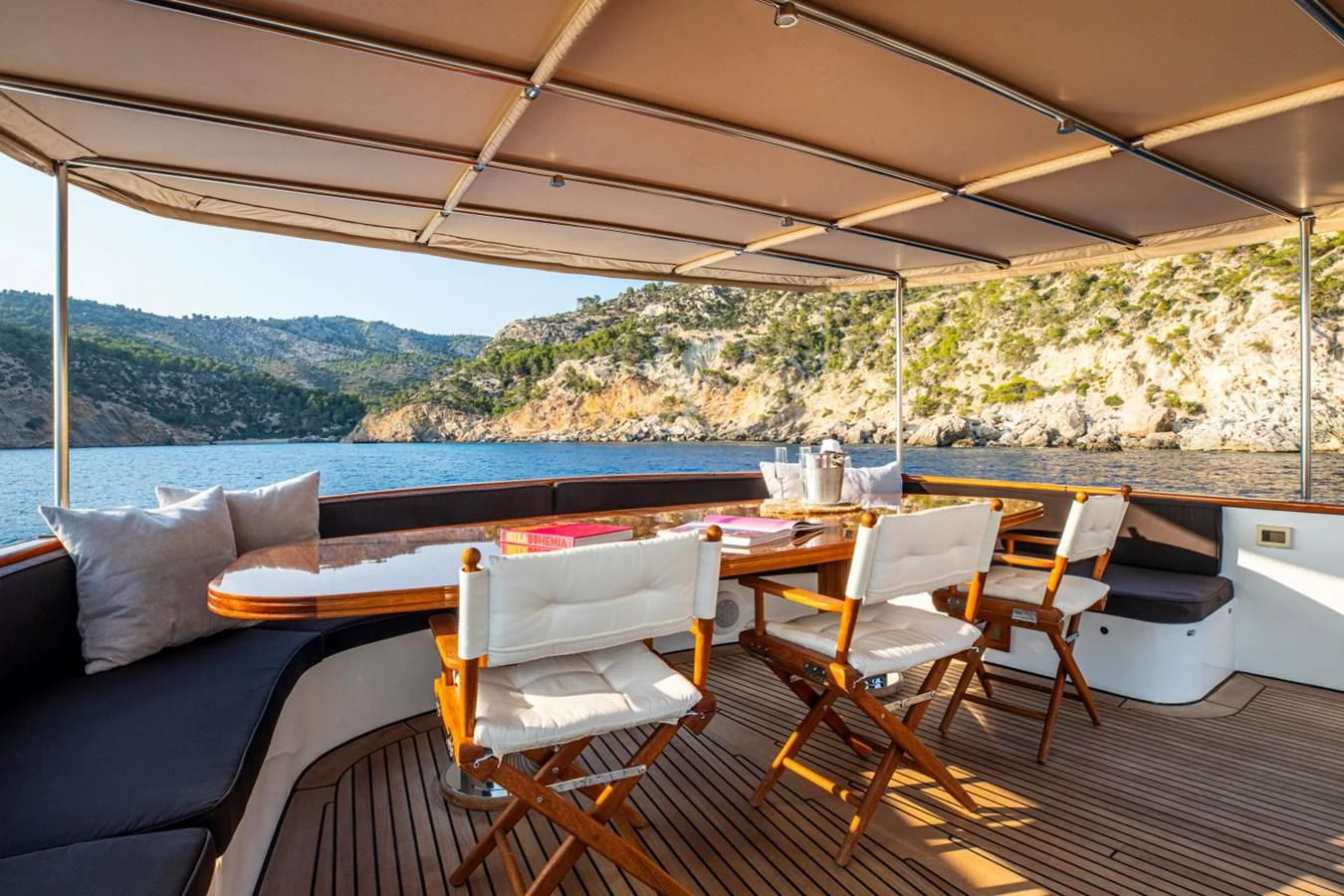 a deck with a table and chairs aboard SANTA MARIA Yacht for Sale