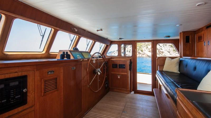 a cabin with a wood paneled interior aboard SANTA MARIA Yacht for Sale