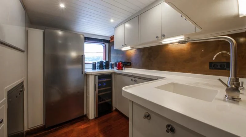 a kitchen with a stainless steel refrigerator aboard SANTA MARIA Yacht for Sale
