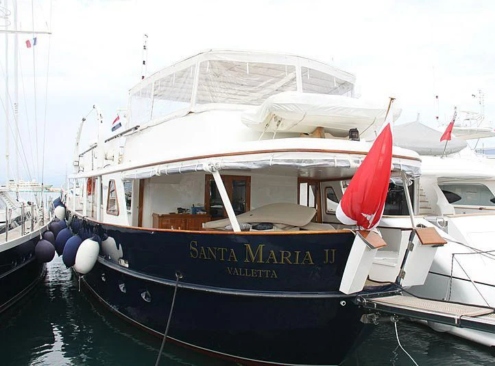 a boat with a flag on the front aboard SANTA MARIA Yacht for Sale