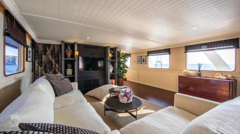 a living room with a couch and a coffee table aboard SANTA MARIA Yacht for Sale