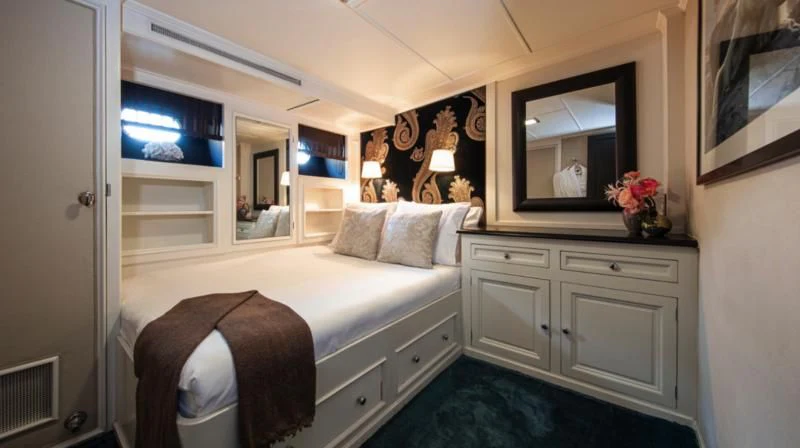 a bedroom with a bed and a mirror aboard SANTA MARIA Yacht for Sale