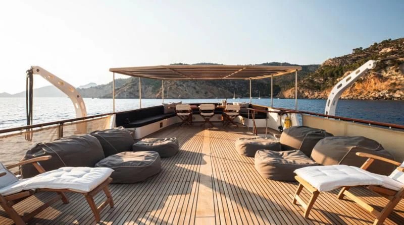 a deck with a large body of water and a boat on it aboard SANTA MARIA Yacht for Sale