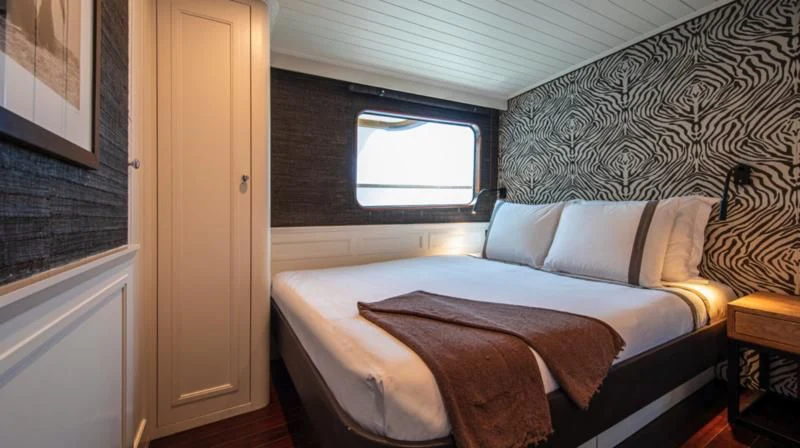 a bed in a room aboard SANTA MARIA Yacht for Sale
