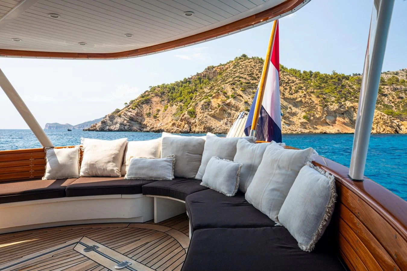 a couch with a flag on it aboard SANTA MARIA Yacht for Sale