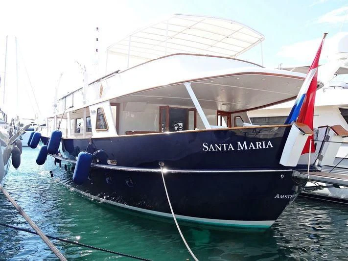 a boat with a flag on the front aboard SANTA MARIA Yacht for Sale