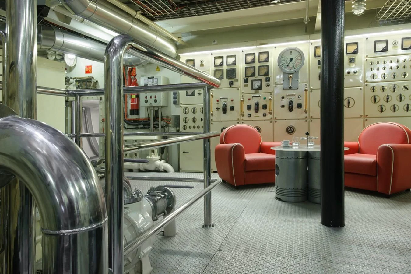 a large room with a few chairs and a large metal shelf aboard NORTH SEA Yacht for Sale