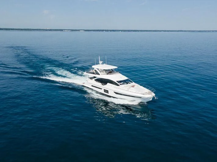 a white boat on the water aboard DIAMOND HANDS Yacht for Sale