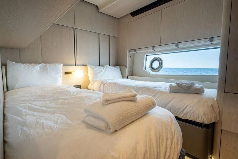 a room with a bed and a window aboard DIAMOND HANDS Yacht for Sale