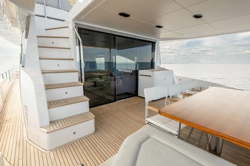 a room with a bed and a table and chairs aboard DIAMOND HANDS Yacht for Sale