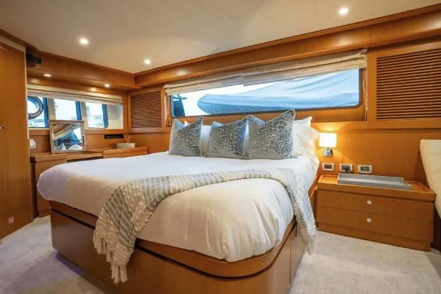a bed with a white sheet aboard VITAMIN SEA Yacht for Sale