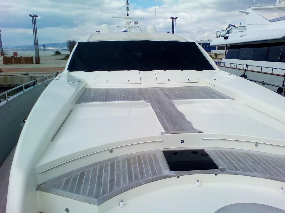 a white yacht in a harbor aboard SUN ANEMOS Yacht for Charter