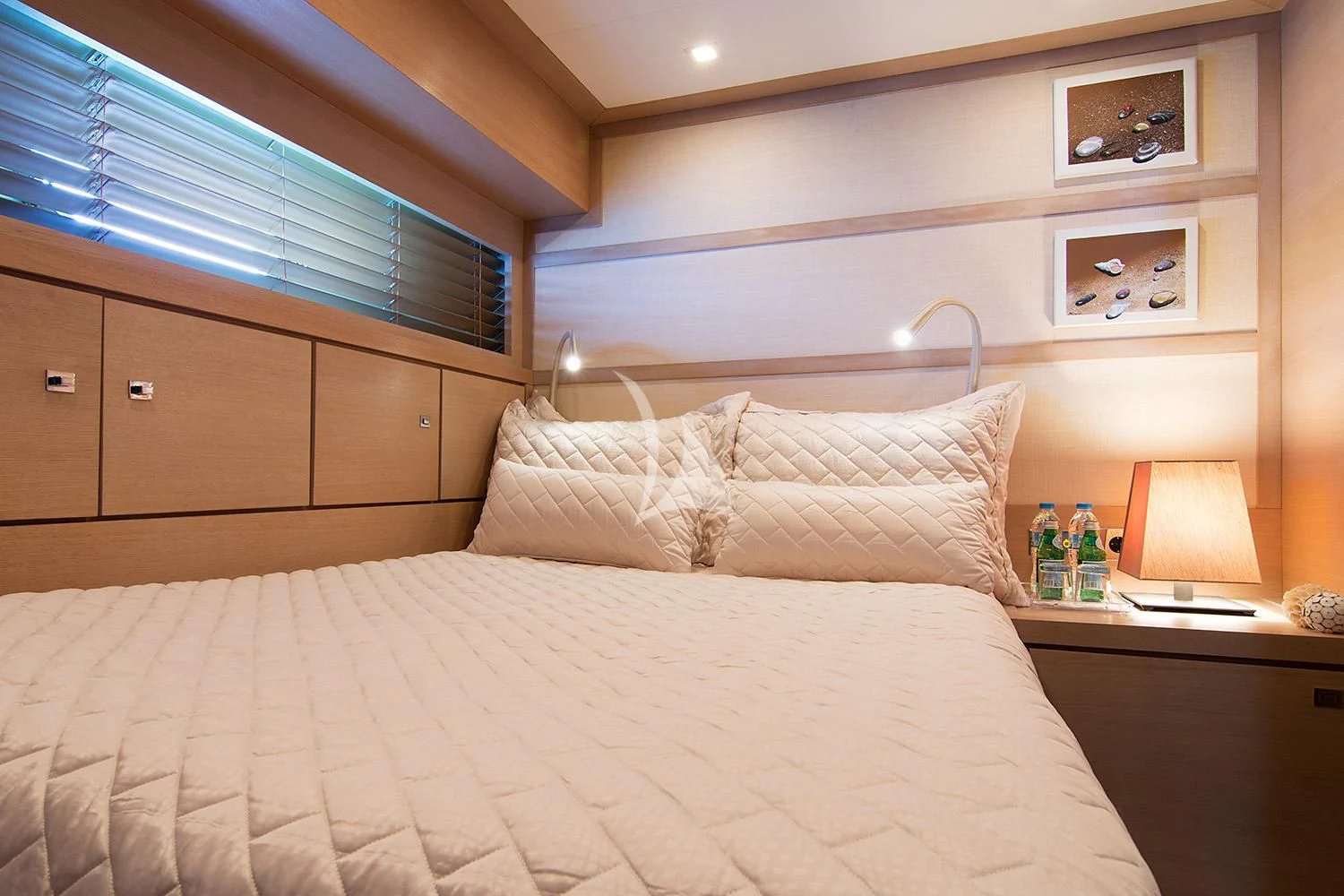 a bed with a white comforter and pillows aboard SUN ANEMOS Yacht for Charter