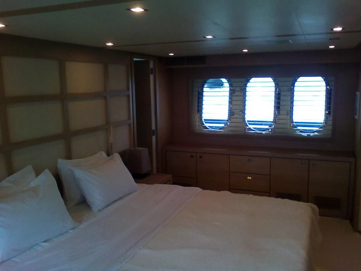 a bed with white sheets aboard SUN ANEMOS Yacht for Charter