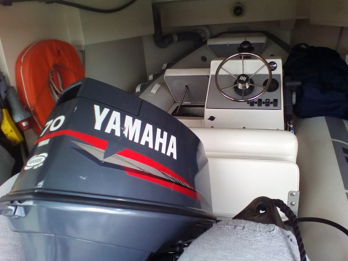 a car with a red and white stripe on the hood aboard SUN ANEMOS Yacht for Charter
