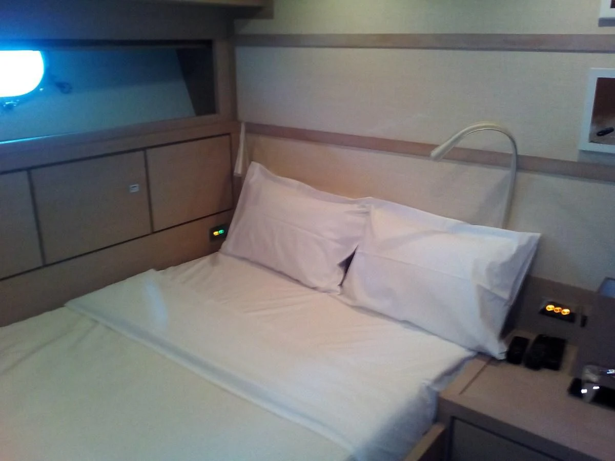 a bed with white sheets aboard SUN ANEMOS Yacht for Charter